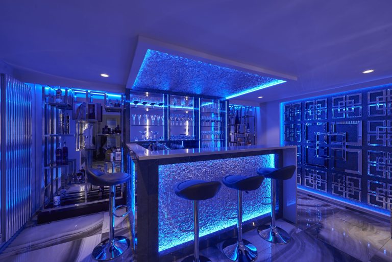 Dark marble home bar with concealed glassware storage
