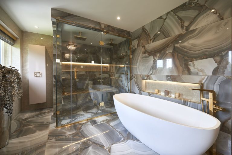 Freestanding bath against a full-height marble wall