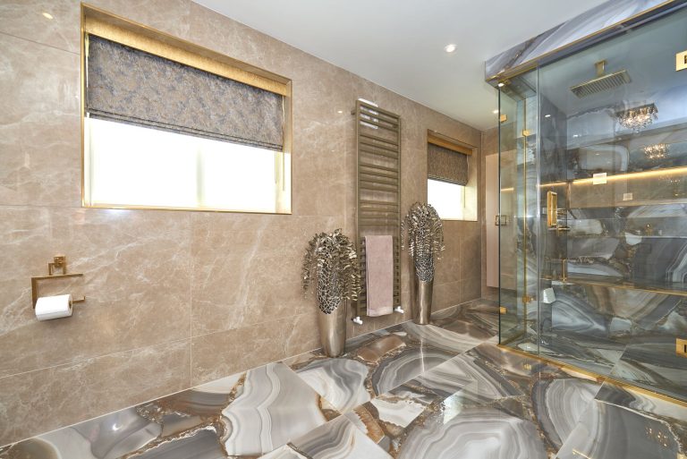Marble bathroom with a walk-in shower and heated rail