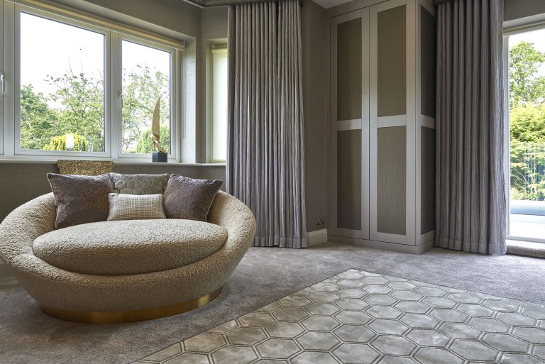 Mirrored wardrobe doors beside the upholstered headboard wall
