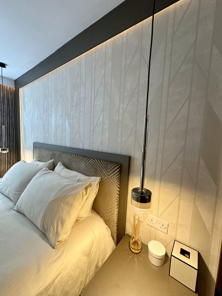 Bedroom with backlit stone panels either side of the bed