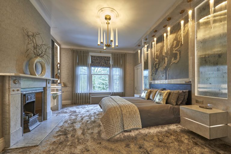 Bed with a laser-cut bedspread and hand-blown glass chandeliers