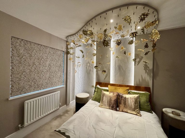 Glass leaves suspended in waves above the bed from a painted ceiling panel