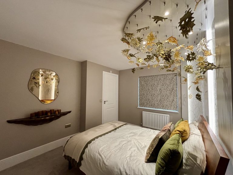 Textured wall covering that mimics bare branches behind a bed