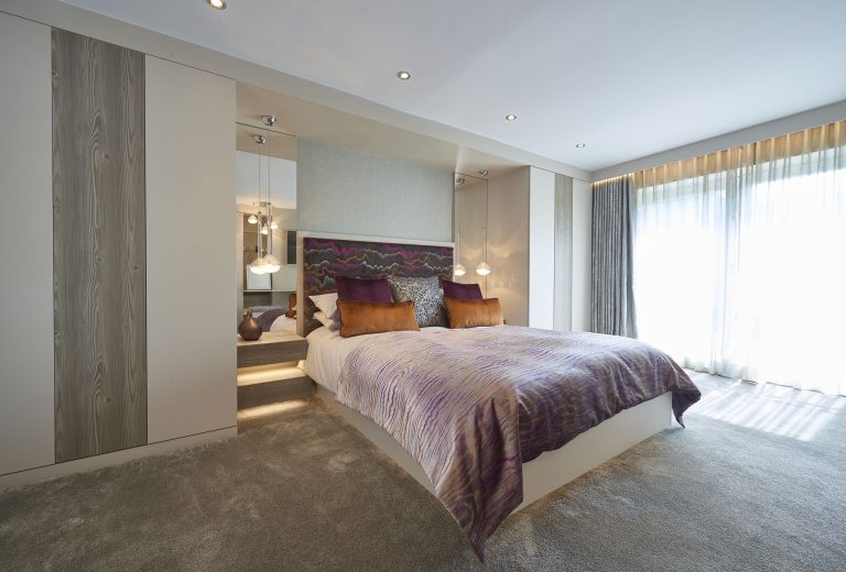 Bedroom with full-height curtains and sheers across the window wall
