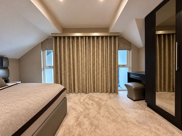 Bedroom with gold curtains drawn across the window wall