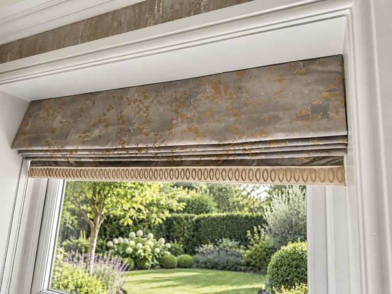 Roman blind in a textured fabric above a garden window