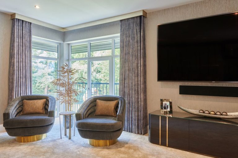 Bay window with curtains and a pair of swivel chairs
