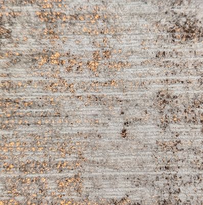 Fabric with copper flecks woven through a pale ground