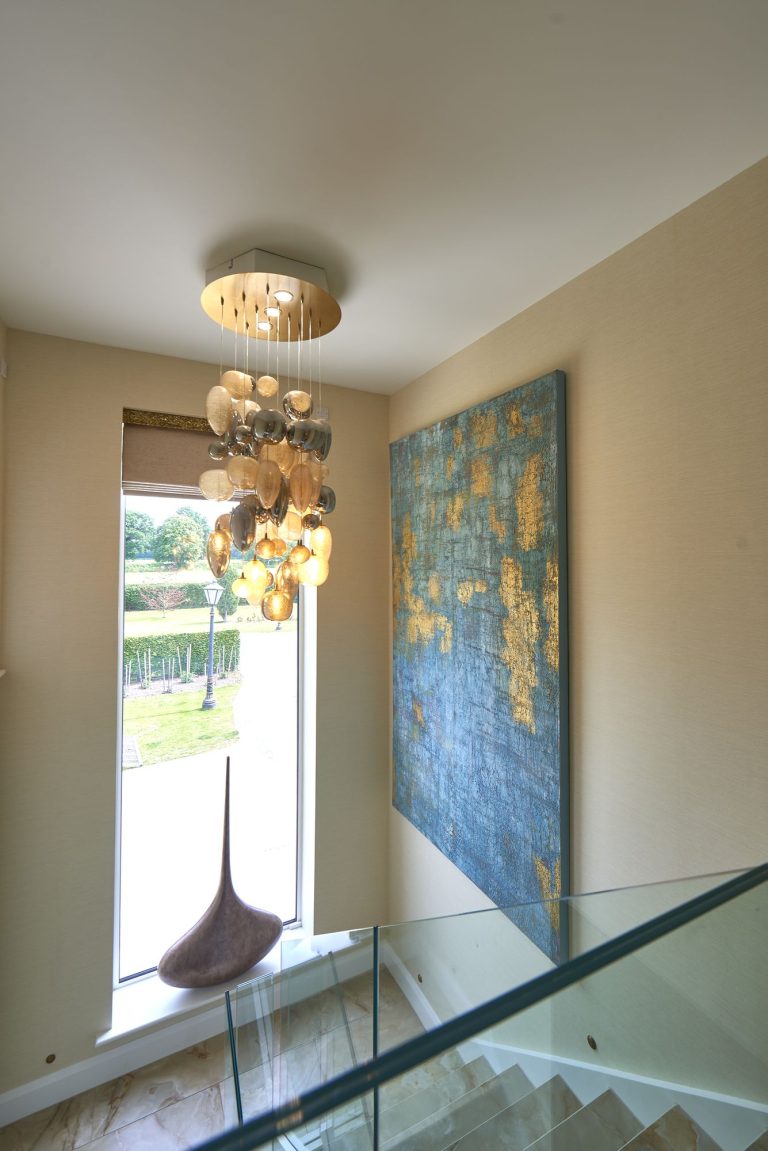 Landing with a cluster pendant and a large canvas beside the window