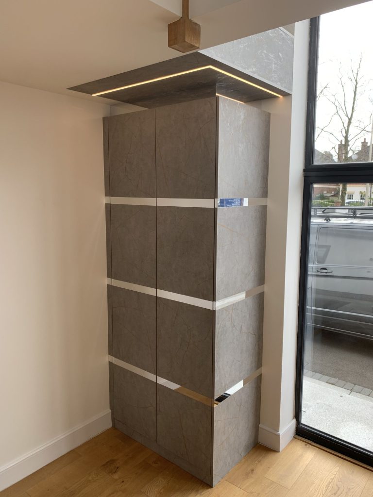 Fitted hall storage in textured panels beside the front door