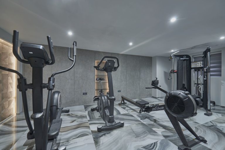 Lit timber wall panel in a home gym finished in marble-effect panelling