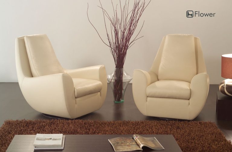 Pair of cream leather armchairs with curved backs