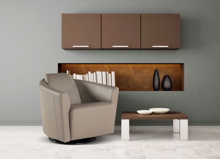 Swivel armchair in pale leather below fitted wall units