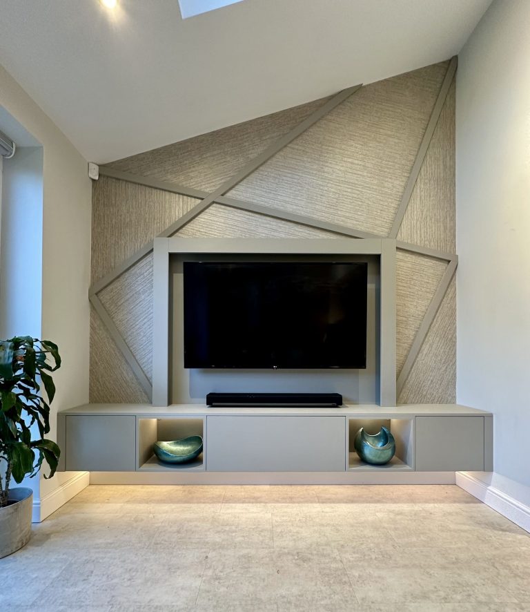 Television wall with textured geometric panelling and a fitted media unit