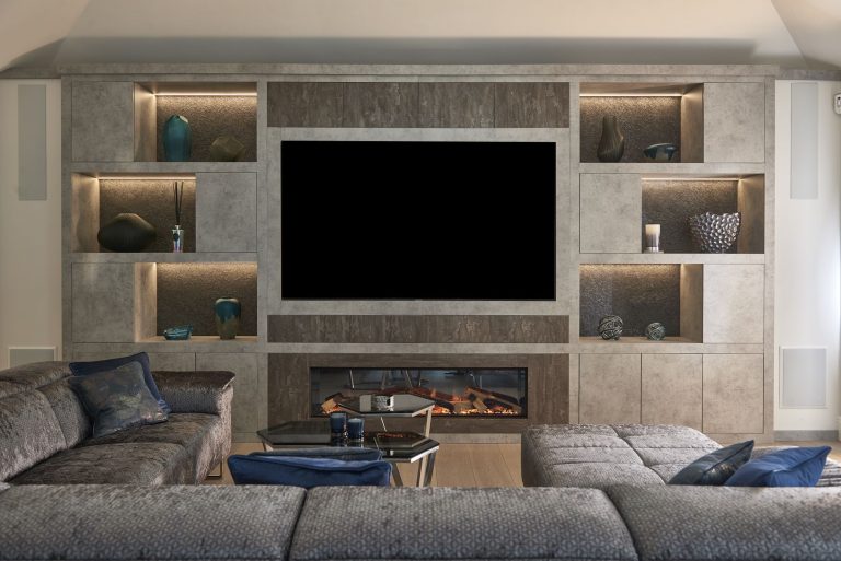 Media wall with lit display niches either side of the screen