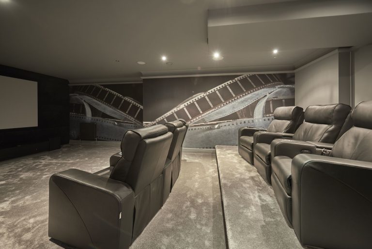 Home cinema with tiered leather recliners and concealed lighting