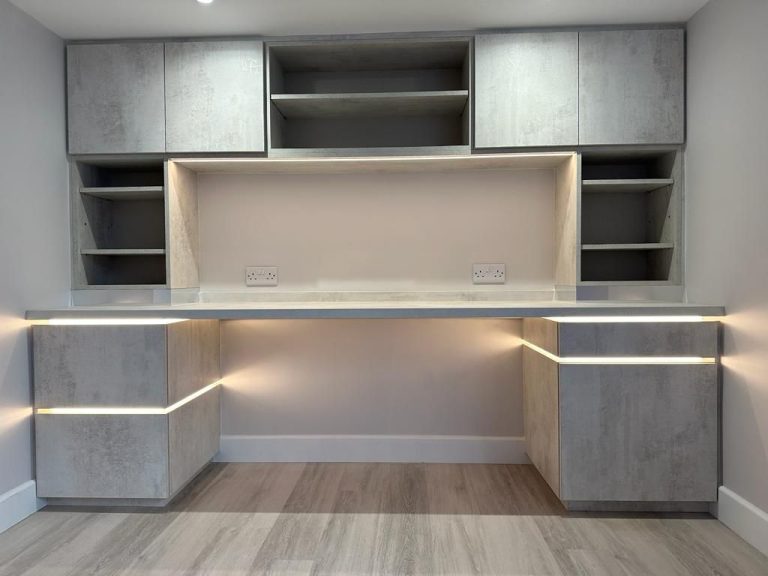 Fitted home office desk with lit shelving above