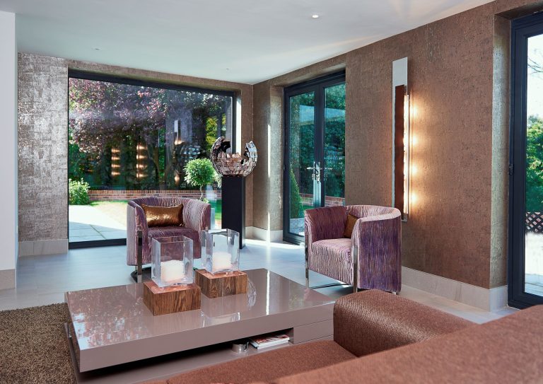 Open-plan living space with a feature wall and garden doors