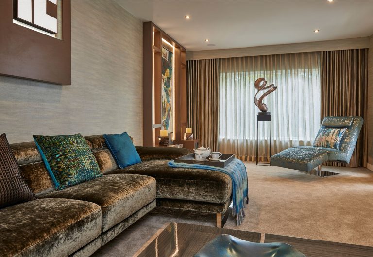 Living room with velvet seating and a sculptural coffee table