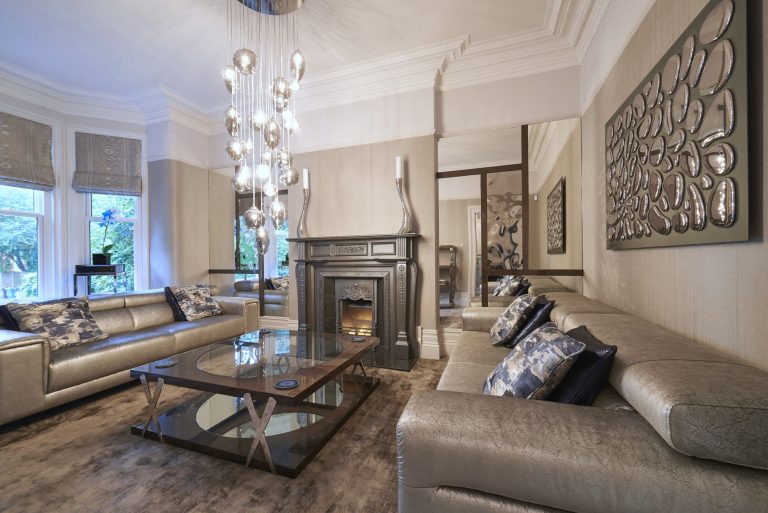 Formal lounge in a Manchester period property with a silver period fireplace and a cascade of mercury glass pendants