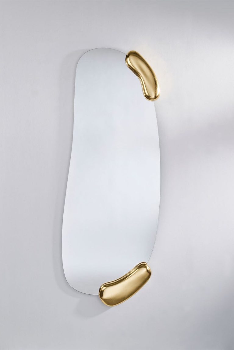 Round wall mirror with a textured metallic frame