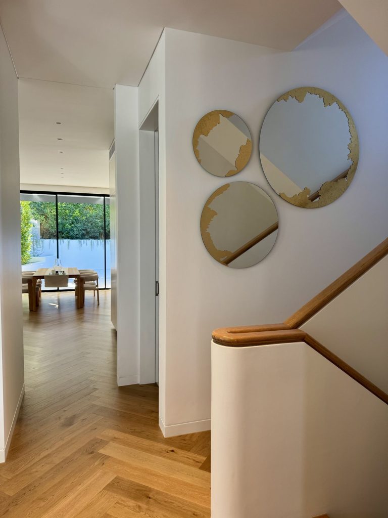 Round mirror with a slim bronze frame