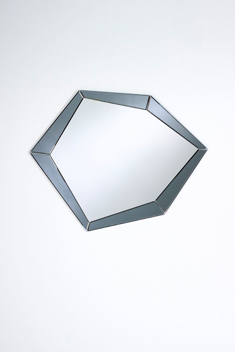Decorative wall mirror with a faceted frame