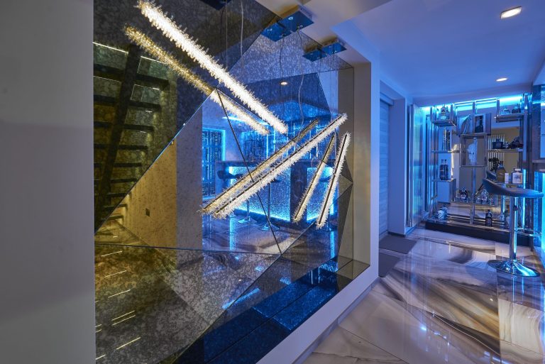 Onyx floor and mirrored wall at the foot of the basement stairs
