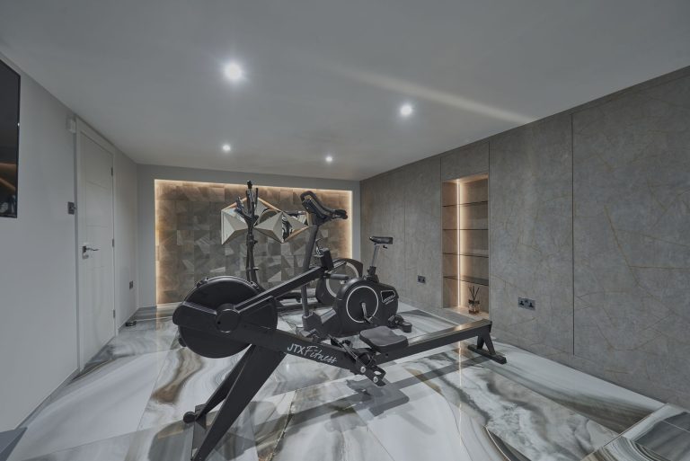 Home gym with a rowing machine on a marble floor