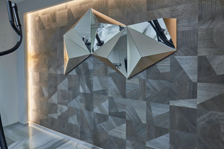 Backlit faceted wall panel in the gym