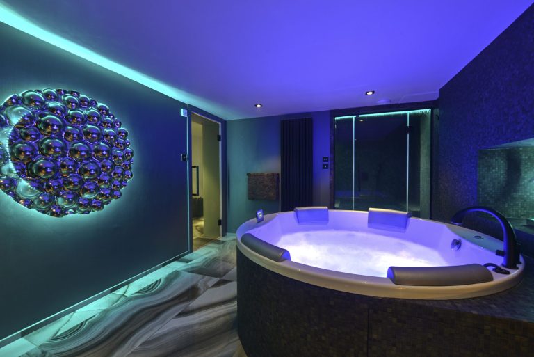 The spa room lit teal, showing the colour changing lighting
