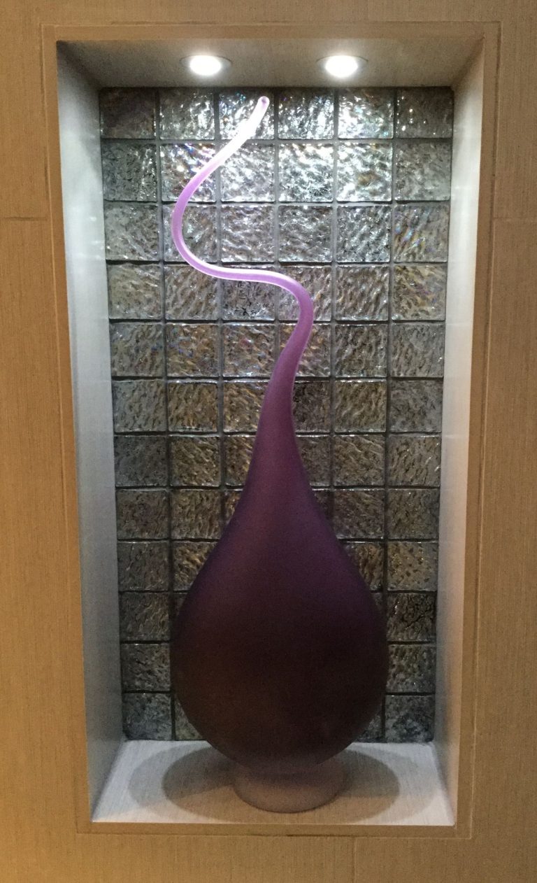 A second glass sculpture in its lit niche