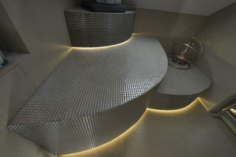 Curved mosaic bench lit from beneath