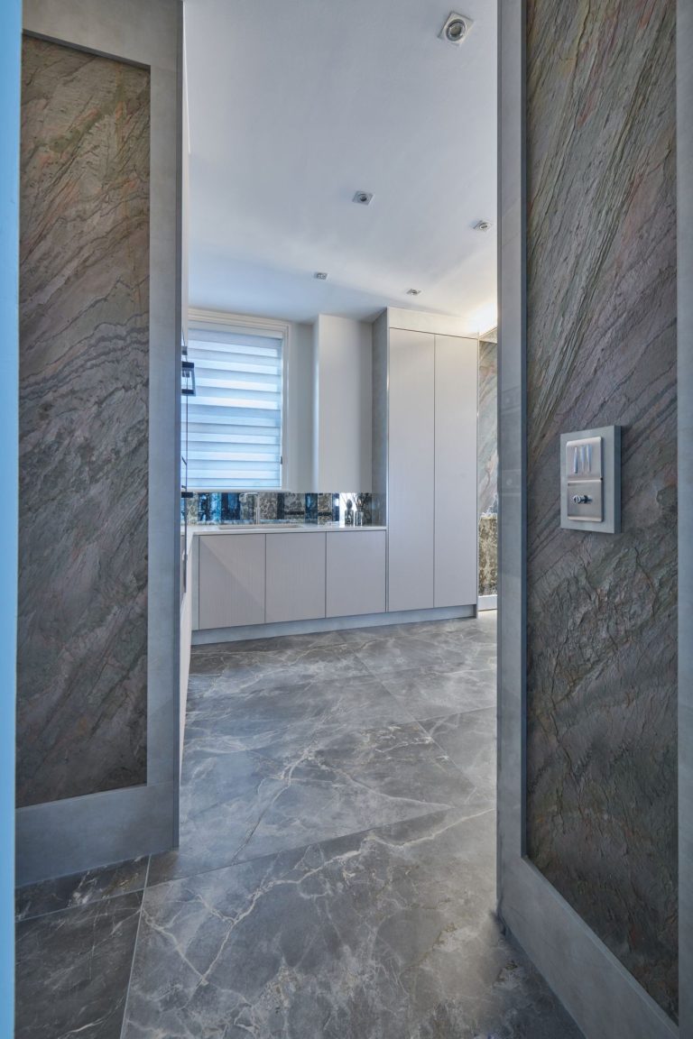 Doorway from the landing into the kitchen with stone flooring