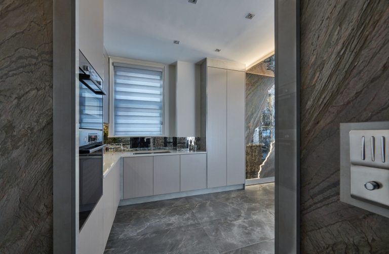 Kitchen units with an integrated oven and the window beyond