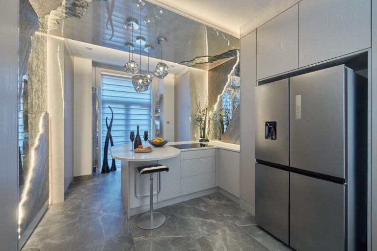 The kitchen with glass pendants above the curved breakfast bar