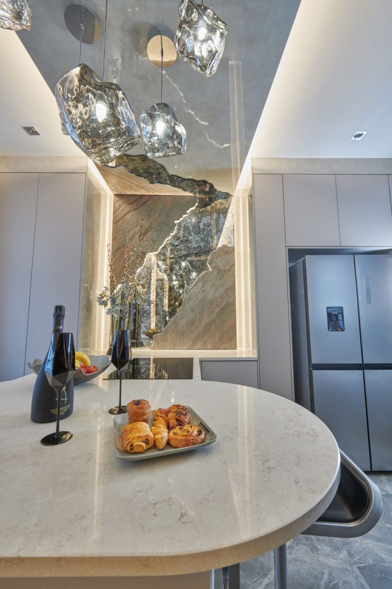 Glass pendants above the breakfast bar with fruit and glasses set out