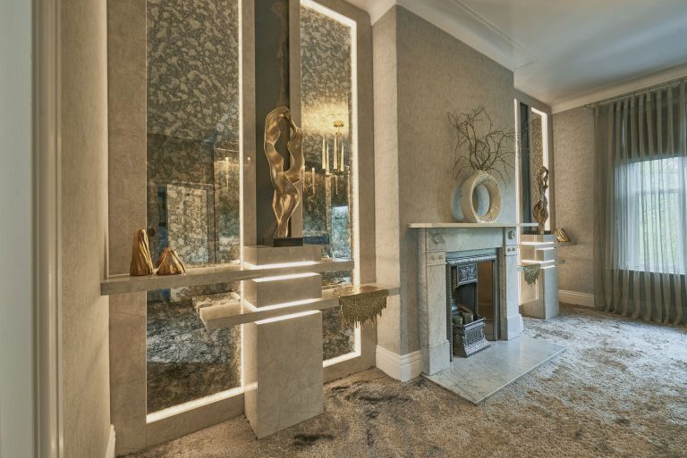 The fireplace wall with mirrored panels either side