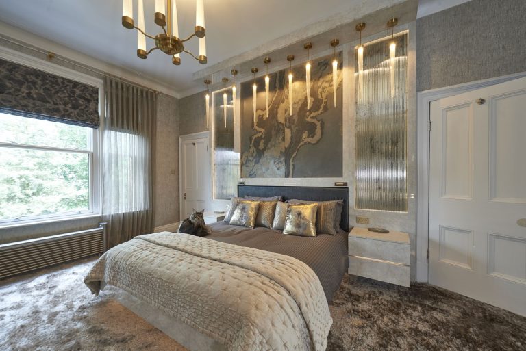 The master bedroom seen towards the door, with the lit panels along the wall