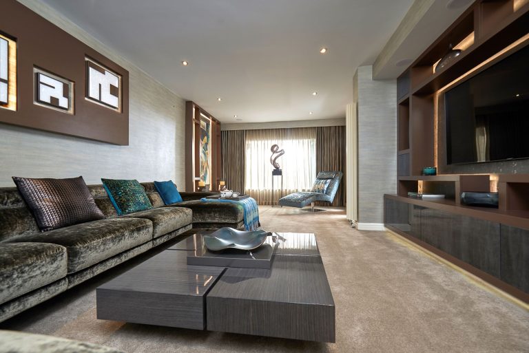 Main sitting room with a long velvet corner sofa and a low coffee table