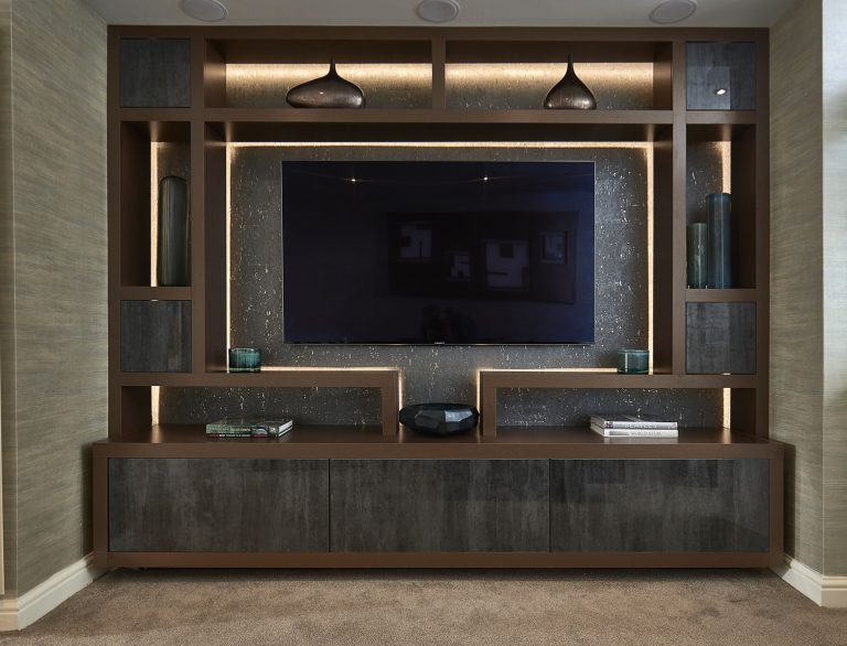 Media wall with a television set into lit joinery and pendants above