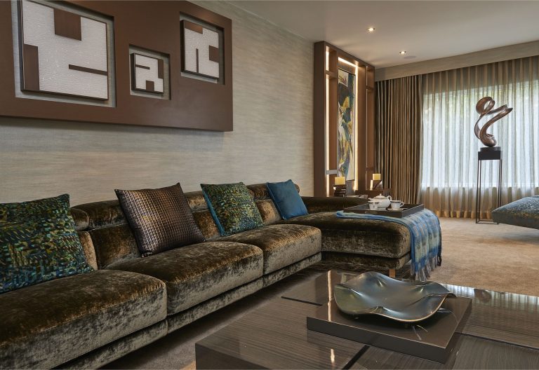 Sofa with blue and bronze cushions, artwork above and the sculpture beyond