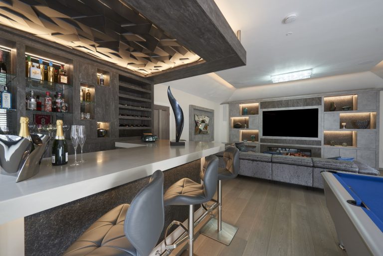 Bar with a three-dimensional lit ceiling feature and the pool table beyond