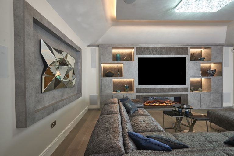 Seating area with framed mirrored artwork above the media wall