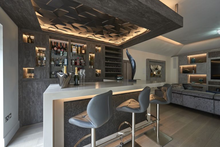 Bar counter with stools below the three-dimensional lighting feature