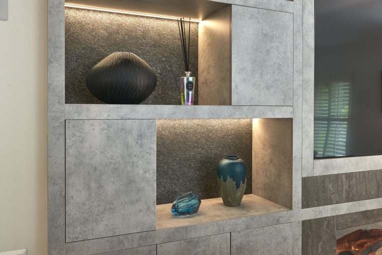 Lit display niches in the media wall holding glass pieces