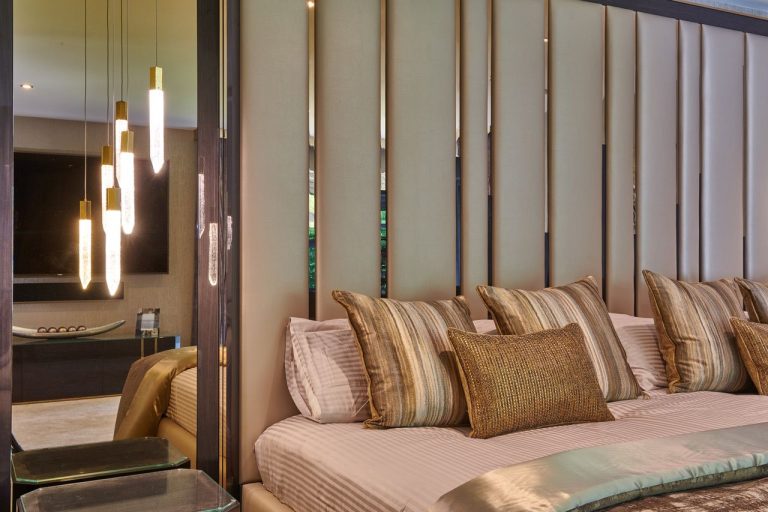 Bronze mirrored panels and pendants behind the bed