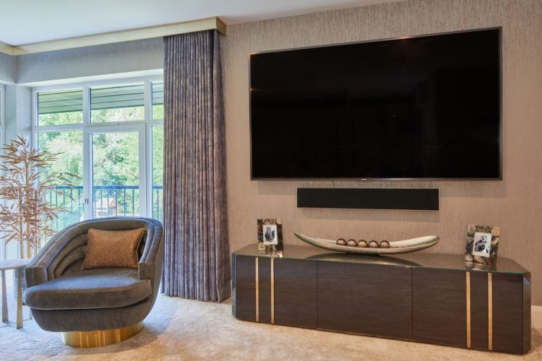 Made to order television unit in dark veneer with bronze detailing