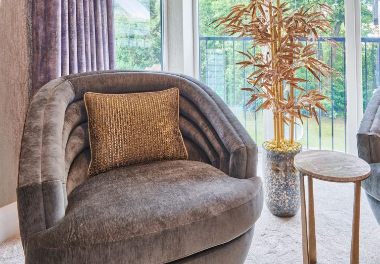 Swivel tub chair in velvet beside a bedroom window